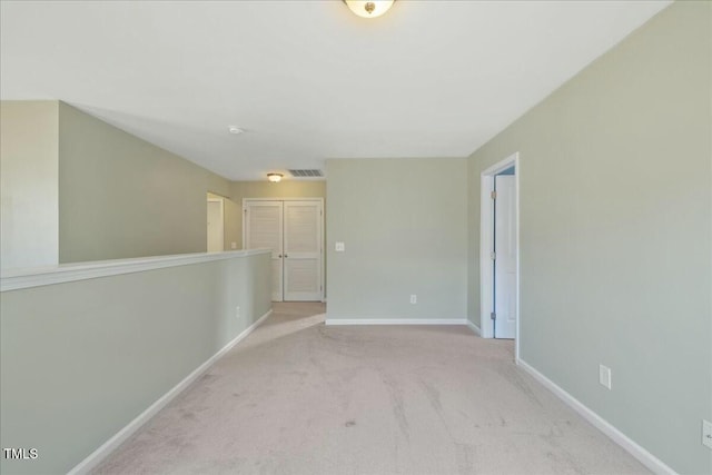 empty room with light colored carpet