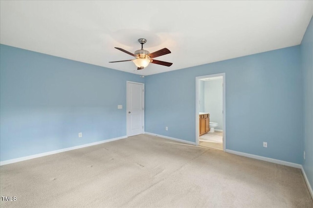 unfurnished bedroom with connected bathroom, light colored carpet, and ceiling fan