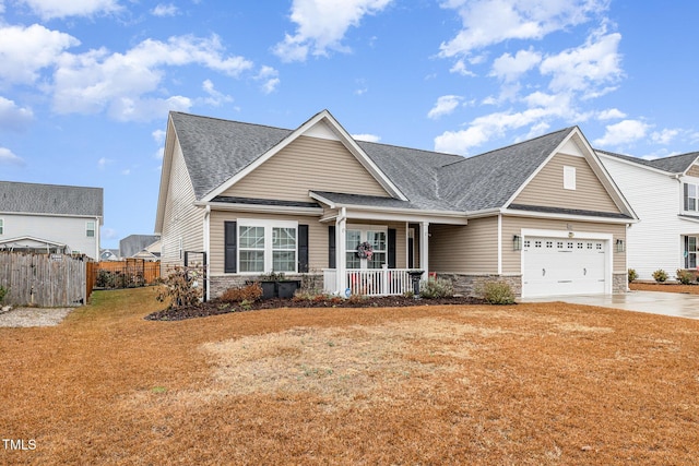 view of front of property with a garage, covered porch, and a front lawn