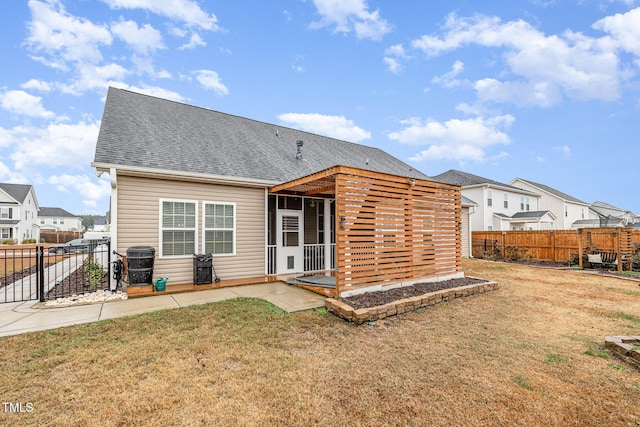 rear view of house featuring a patio and a yard