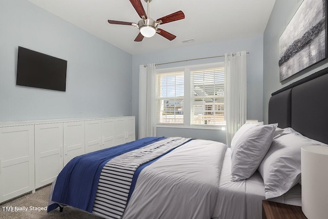 bedroom featuring ceiling fan and carpet