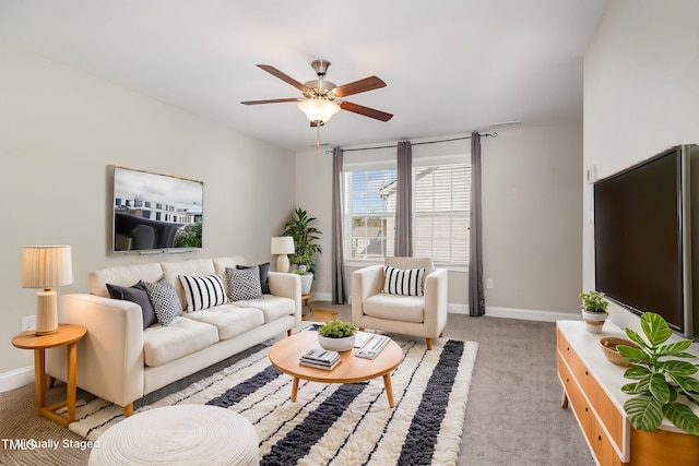 carpeted living room with ceiling fan