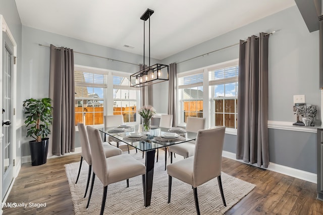 dining area featuring an inviting chandelier and hardwood / wood-style floors