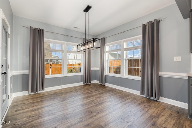 unfurnished dining area with dark hardwood / wood-style flooring