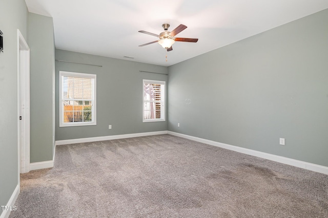 carpeted empty room featuring ceiling fan