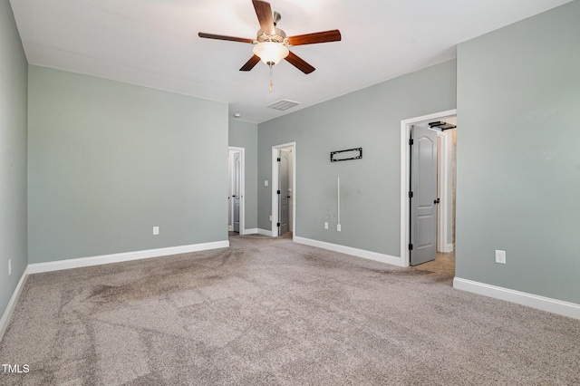 unfurnished bedroom with light colored carpet and ceiling fan