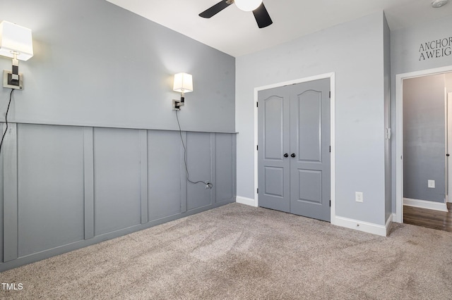 unfurnished bedroom featuring ceiling fan and carpet floors