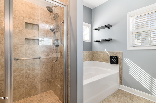 bathroom with tile patterned floors and shower with separate bathtub