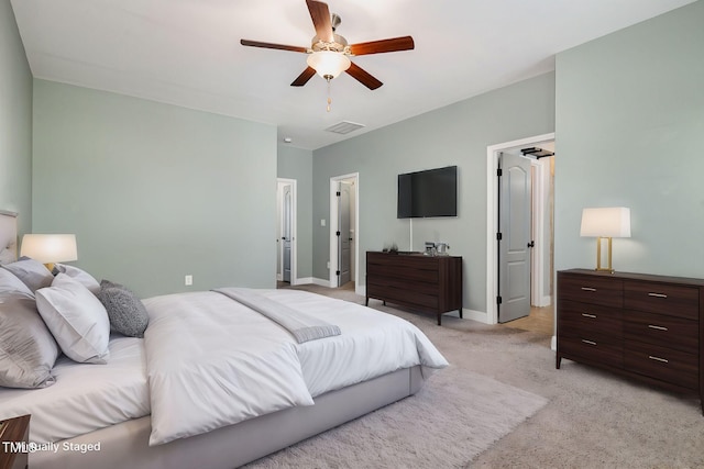 bedroom featuring light colored carpet and ceiling fan