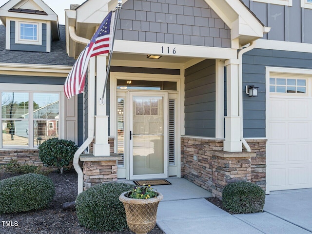 view of exterior entry with a garage