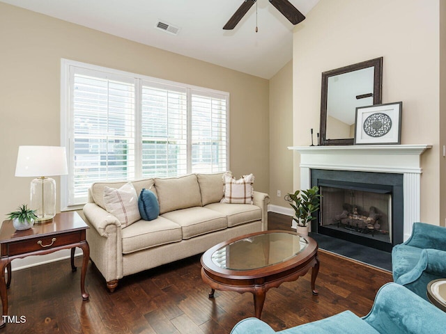 living room with ceiling fan, lofted ceiling, and dark hardwood / wood-style flooring