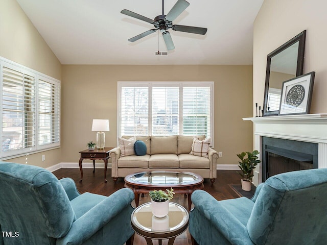 living room featuring ceiling fan, dark hardwood / wood-style floors, and vaulted ceiling