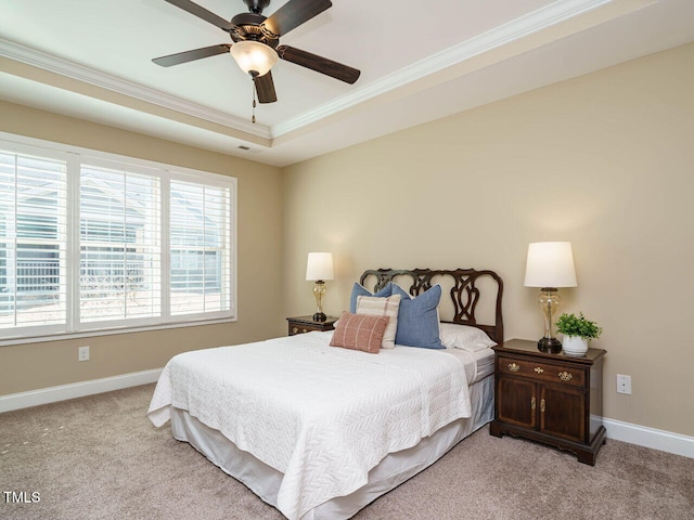 bedroom featuring crown molding, ceiling fan, a raised ceiling, and light carpet