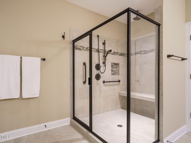 bathroom featuring a shower with shower door