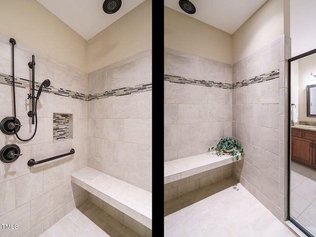 bathroom featuring a tile shower and vanity