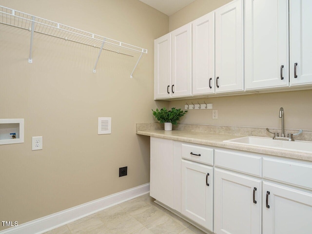 laundry area featuring cabinets, sink, and washer hookup