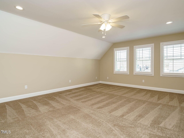 bonus room featuring lofted ceiling, carpet flooring, and ceiling fan