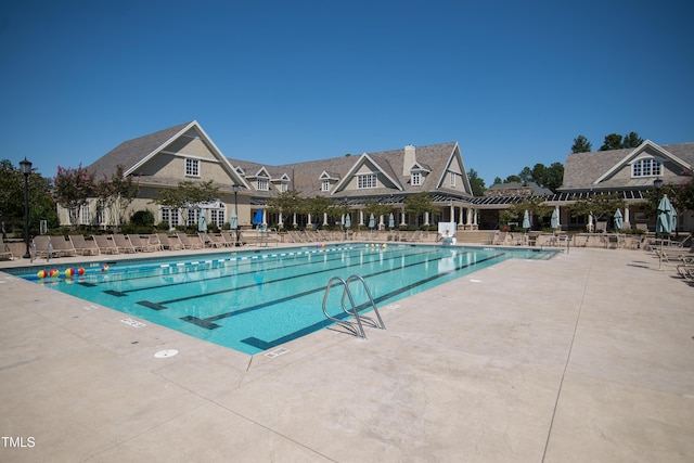 view of swimming pool featuring a patio area