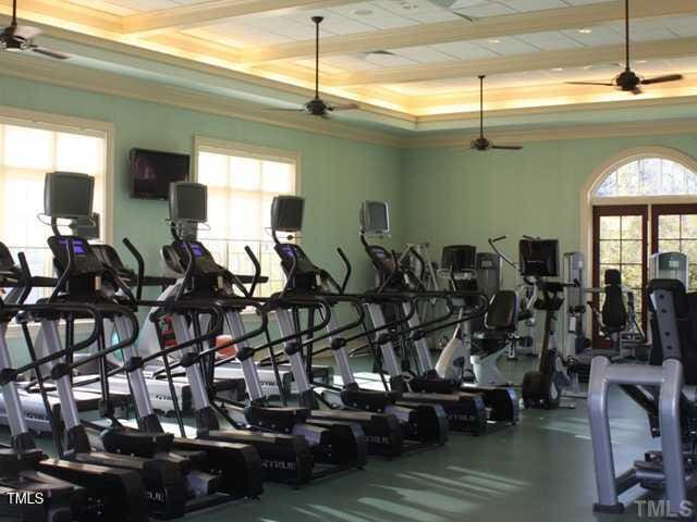 gym featuring plenty of natural light and ceiling fan