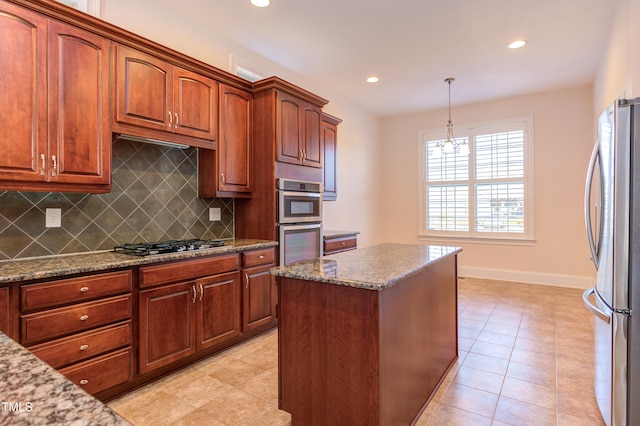 kitchen featuring tasteful backsplash, stone countertops, decorative light fixtures, a center island, and stainless steel appliances