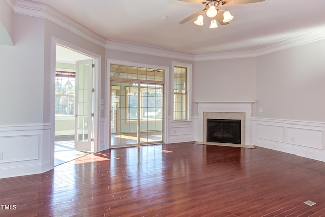 unfurnished living room featuring dark hardwood / wood-style flooring, crown molding, and ceiling fan