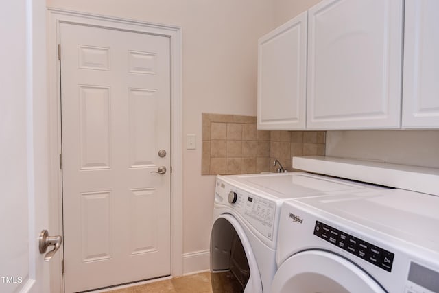 laundry area with cabinets and washing machine and dryer