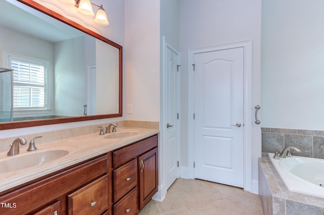 bathroom featuring vanity, tiled tub, and tile patterned floors