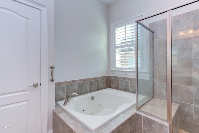 bathroom featuring separate shower and tub