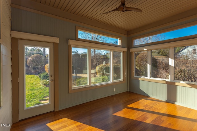 unfurnished sunroom with ceiling fan, a healthy amount of sunlight, and wooden ceiling