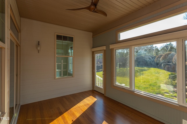 unfurnished sunroom featuring wooden ceiling and ceiling fan