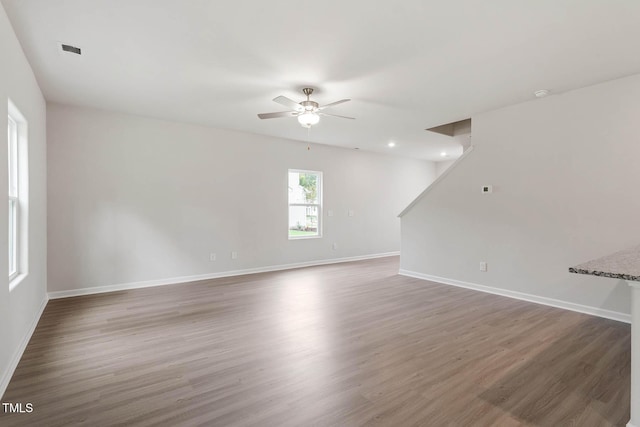 empty room with wood-type flooring and ceiling fan