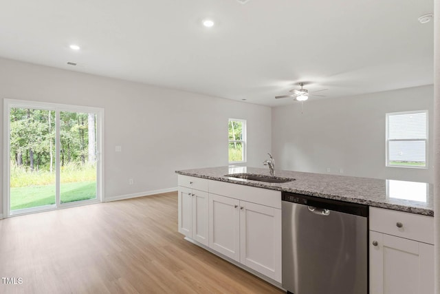 kitchen featuring white cabinetry, sink, light stone countertops, and dishwasher