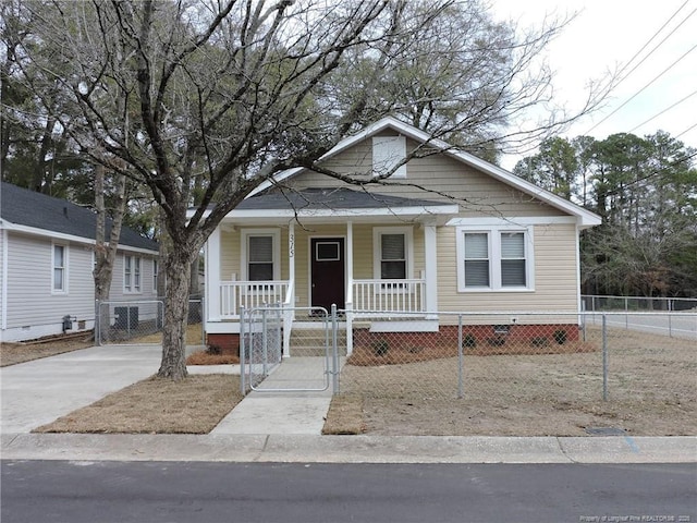 bungalow-style home featuring covered porch, a fenced front yard, a gate, and crawl space