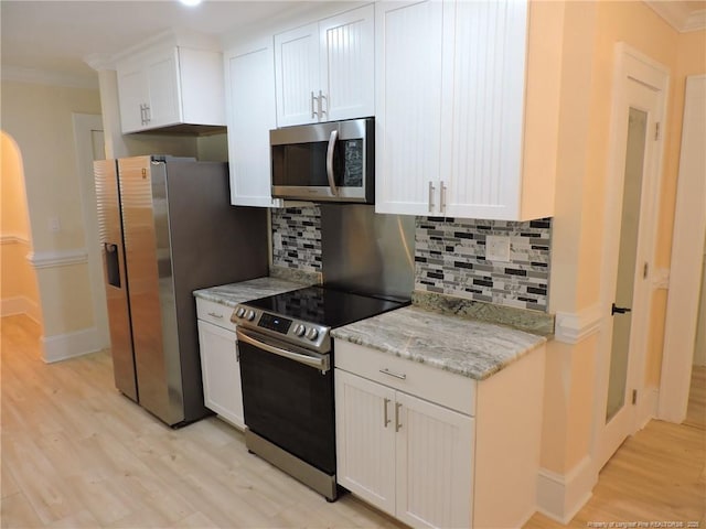 kitchen featuring white cabinetry, light stone counters, and appliances with stainless steel finishes