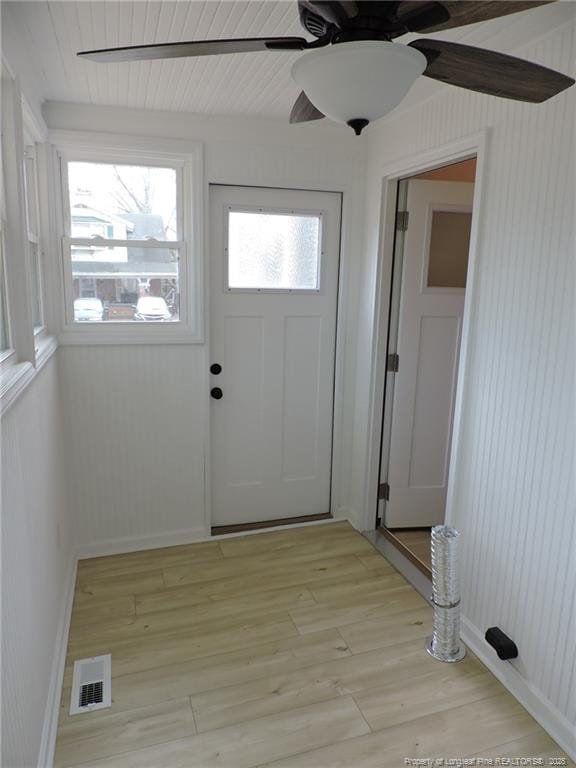 doorway to outside with ceiling fan and light hardwood / wood-style flooring