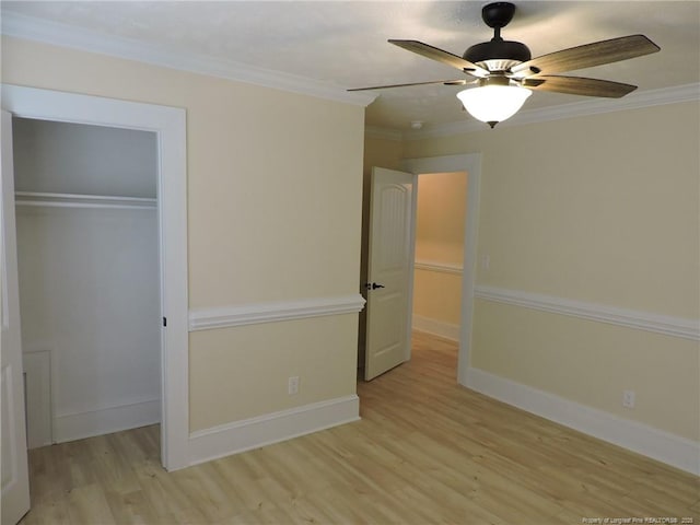 unfurnished bedroom with crown molding, a closet, ceiling fan, and light hardwood / wood-style flooring