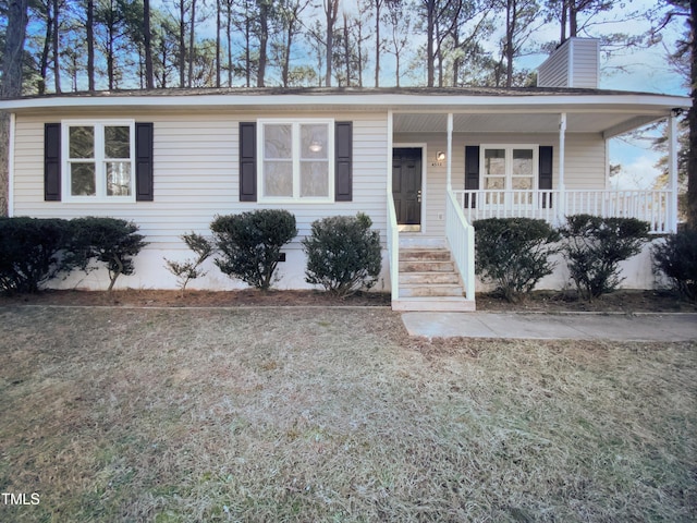 ranch-style home with covered porch and a front lawn