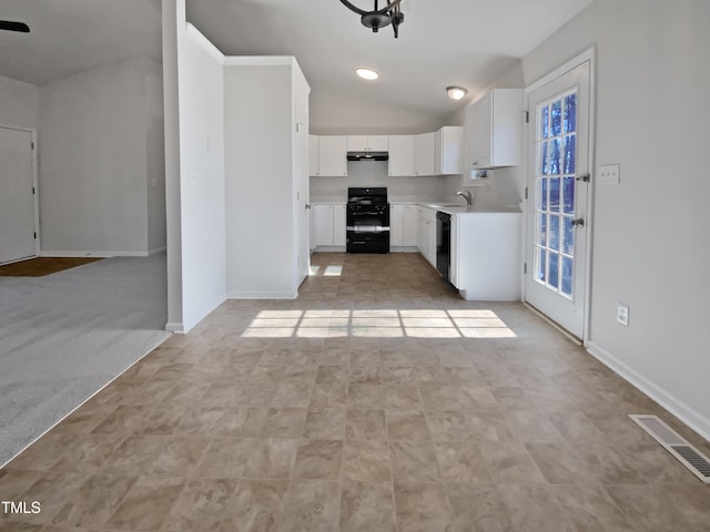 kitchen featuring vaulted ceiling, sink, white cabinets, black appliances, and light carpet