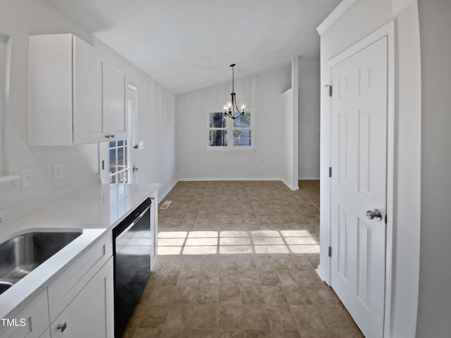 kitchen featuring white cabinetry, dishwasher, sink, hanging light fixtures, and an inviting chandelier