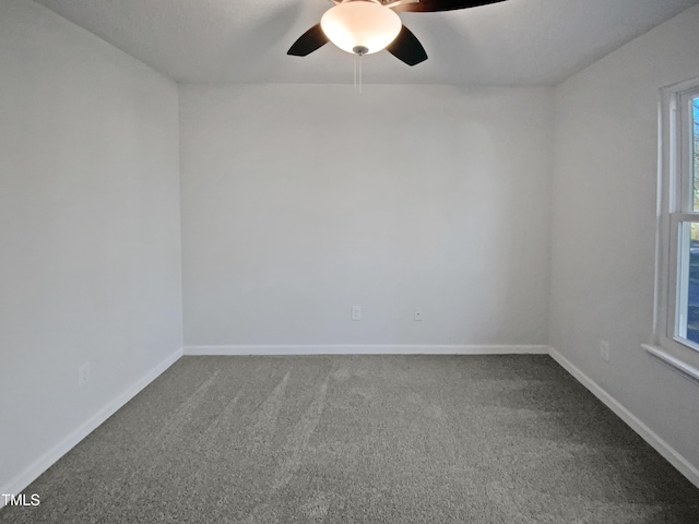 carpeted spare room with ceiling fan