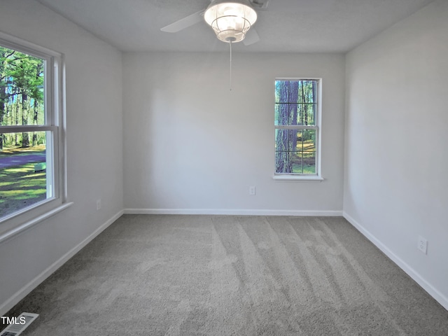 carpeted spare room with ceiling fan