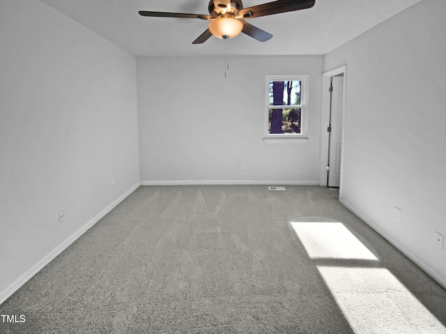 empty room featuring carpet floors and ceiling fan