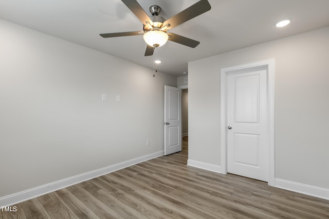 unfurnished bedroom with ceiling fan and light hardwood / wood-style floors