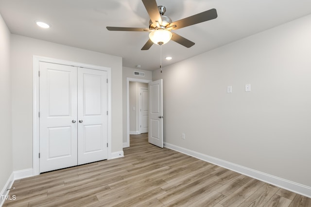 unfurnished bedroom with ceiling fan, a closet, and light hardwood / wood-style flooring