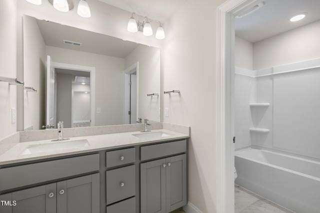 bathroom with vanity and bathtub / shower combination