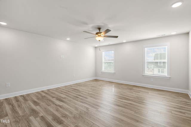 empty room with ceiling fan and light wood-type flooring