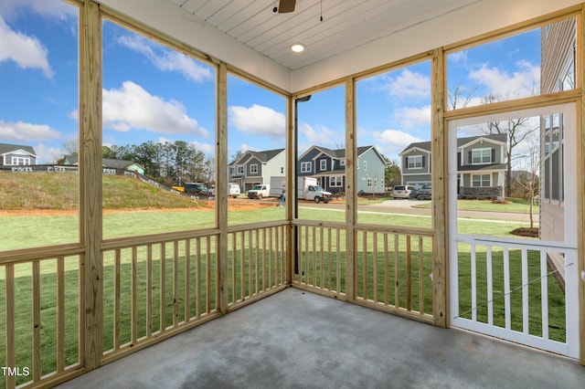 unfurnished sunroom featuring ceiling fan