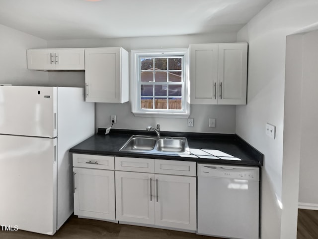 kitchen featuring sink, white cabinets, and white appliances