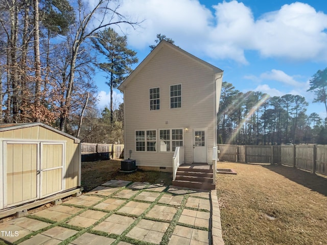 back of property featuring a shed and a patio