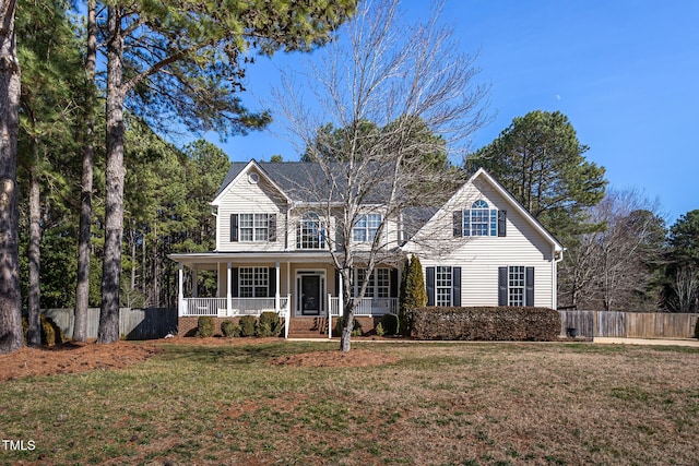 view of front of home with covered porch and a front lawn